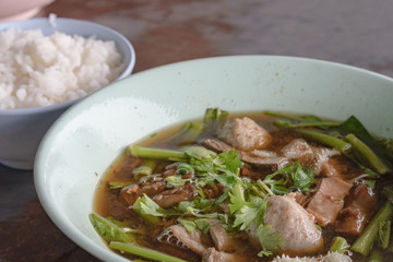 Thailand traditional ekaehla beef soup and cooked rice on the woodden table. Food thai style.
