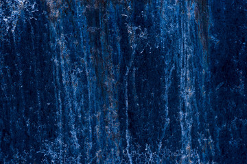 Old metal surface painted in bright blue color - grunge background
