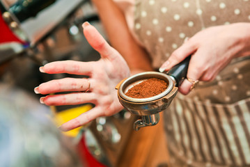 Fototapeta na wymiar barista woman prepares a holder with ground coffee