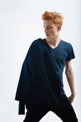 Jacket. Handsome earnest dark-eyed young man wearing a black jacket on his shoulder and looking at...