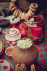 Set the table for the Shrovetide Maslenitsa. Pancakes, porridge in the jug.