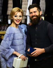 Guy with beard and woman buy furry coat