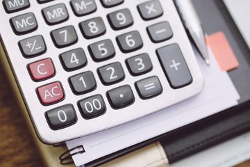 Calculator and pen,notepad. concept Calculating and taking notes.