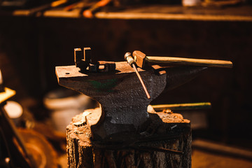 Fototapeta na wymiar Hand anvil. Tools in old blacksmith shop