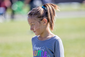 Cute young girl with messsy hair in the park