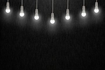 Light bulbs on dark grey texture background