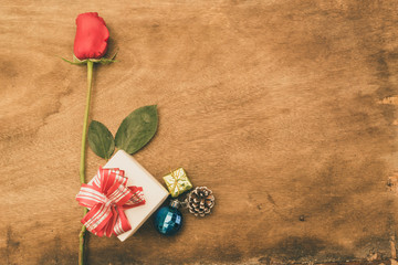 Flat lay image of Valentines Day Background with Gift Box and Red Rose on Wood Table Rustic style