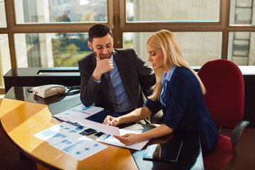 Young business people working together on paper work