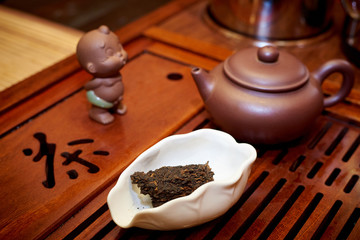 Tea ceremony. Dry black tea in a white bowl