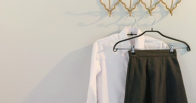 Formal shirt and skirt hanging on hook 