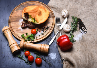 Closed pizza with meat filling, grey background. Rustic cuisine