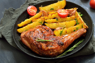Fried chicken leg and potato wedges