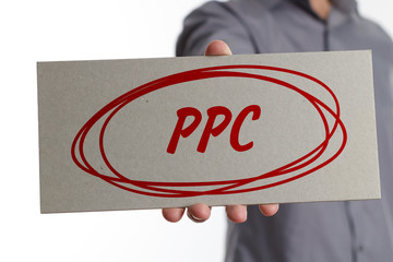 The concept of business, technology, the Internet and the network. Young businessman showing inscription: PPC