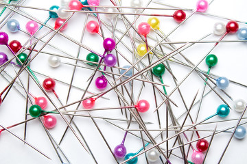 dressmaker pins on white background