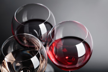 Glasses of  pink , red and white wine .