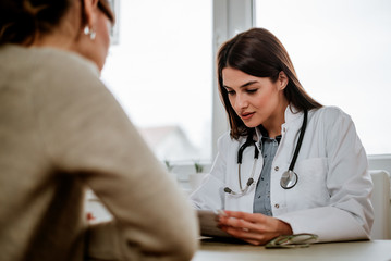 Female doctor inspecting test results.