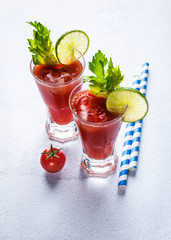 Cocktail Bloody Mary with ice in glasses on a stone table
