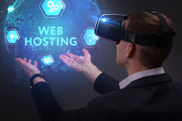 Business, Technology, Internet and network concept. Young businessman working on a virtual screen of the future and sees the inscription: Web hosting