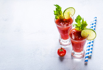 Cocktail Bloody Mary with ice in glasses on a stone table