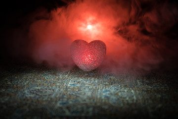 Fototapeta premium Burning LED heart. Valentine concept. Dark toned foggy background.