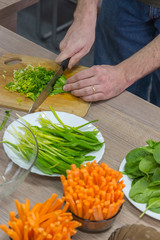 Cooking raw vegan spreads and sauces for a party with a variety of gluten free finger food and healthy snacks rich in vitamins