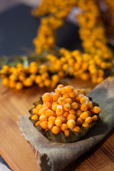 Fresh and ripe sea buckthorn berries in a metal bowl.