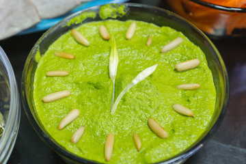 Cooking raw vegan spreads and sauces for a party with a variety of gluten free finger food and healthy snacks rich in vitamins