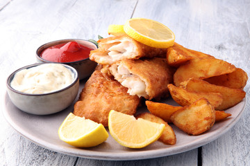 traditional British fish and chips with potato and lemon