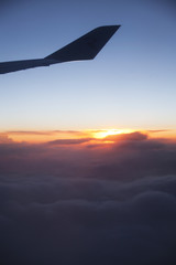 Fototapeta na wymiar Airplane wing silhouette at sunset sky.