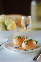 Ukarnian food - round pastries pampushki on ceramic plate.