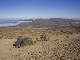 Fototapeta na wymiar desert volcanic landscape with purple mountains in el teide national nature park with Huevos del Teide (Eggs of Teide) accretionary lava balls on clear blue sky background