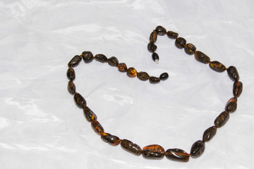 Amber necklace on a light background, jewelry made of natural amber.