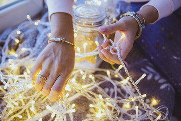 Women's jewelry on the hand. Ring, bracelet and garland.
