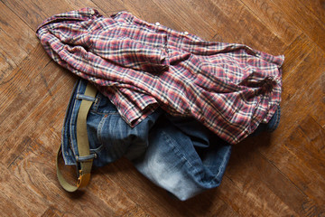 Fototapeta na wymiar man clothes thrown on wooden floor
