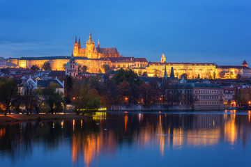 Fototapeta na wymiar Prague, view of illuminated Prague castle (Prazsky Hrad) with reflection in the water, night scenic cityscape, world famous historical heritage of Czech Republic