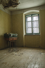 Room in an abandoned house with old suitcases in the corner