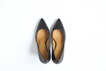 Fashionable medium heeled women's leather wedge shoes isolated on white.