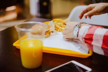 Naklejka na ściany i meble woman eat fast food in the mall