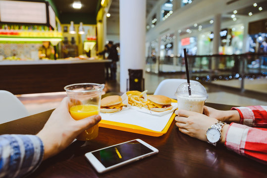 couple sit in cafe inside mall eat and drink