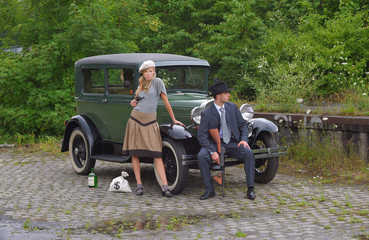 Two models get dressed up in 1930's style vintage fashion clothes and act the role of the gangster...