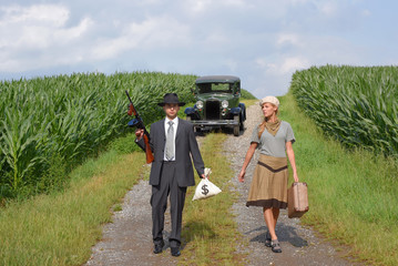 Two models get dressed up in 1930's style vintage fashion clothes and act the role of the gangster duo Bonnie and Clyde.
