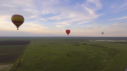 Aerial view Hot air balloons in the sky over a field in the countryside in the beautiful sky and sunset. Aerostat fly in the countryside.