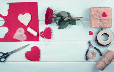 Workspace with tools for handmade and sewing felt hearts for Valentines Day
