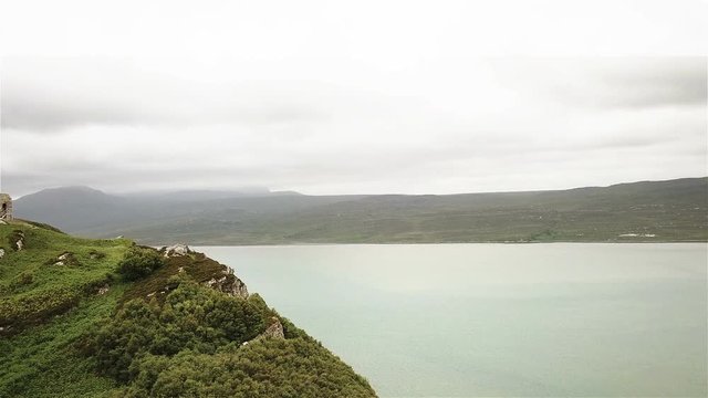 Castle Varrich and the Kyle of Tongue, The Highlands, Scotland; reverse aerial drone reveal