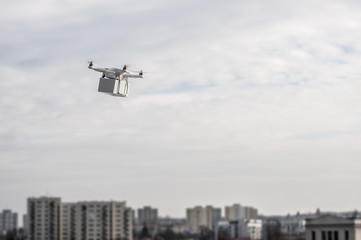 Fototapeta na wymiar Technological delivery innovation - fast drone delivery concept above town