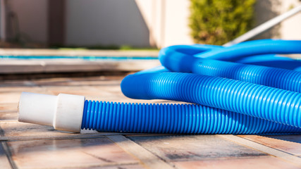 Blue plastic hose for cleaning a swimming pool, Yesulskaya, Krasnodar, Russia. Close-up.