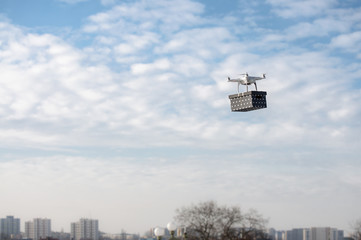 Technological delivery innovation - fast drone delivery concept above town