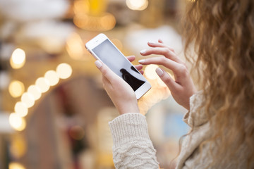 Beautiful female hands holding a mobile phone,
