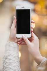 Beautiful female hands holding a mobile phone,