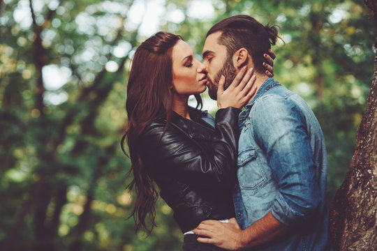 Beautiful young woman kissing handsome man